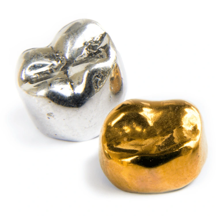 Two scrap palladium and gold dental crowns on a white background