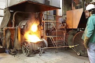 A melter handling molten precious metals in a crucible.