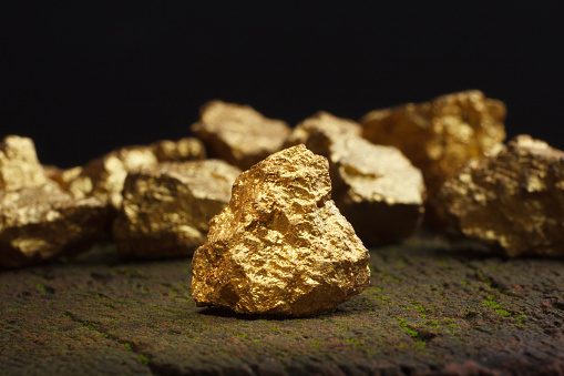 Gold is mined from the earth in the form of gold ore.