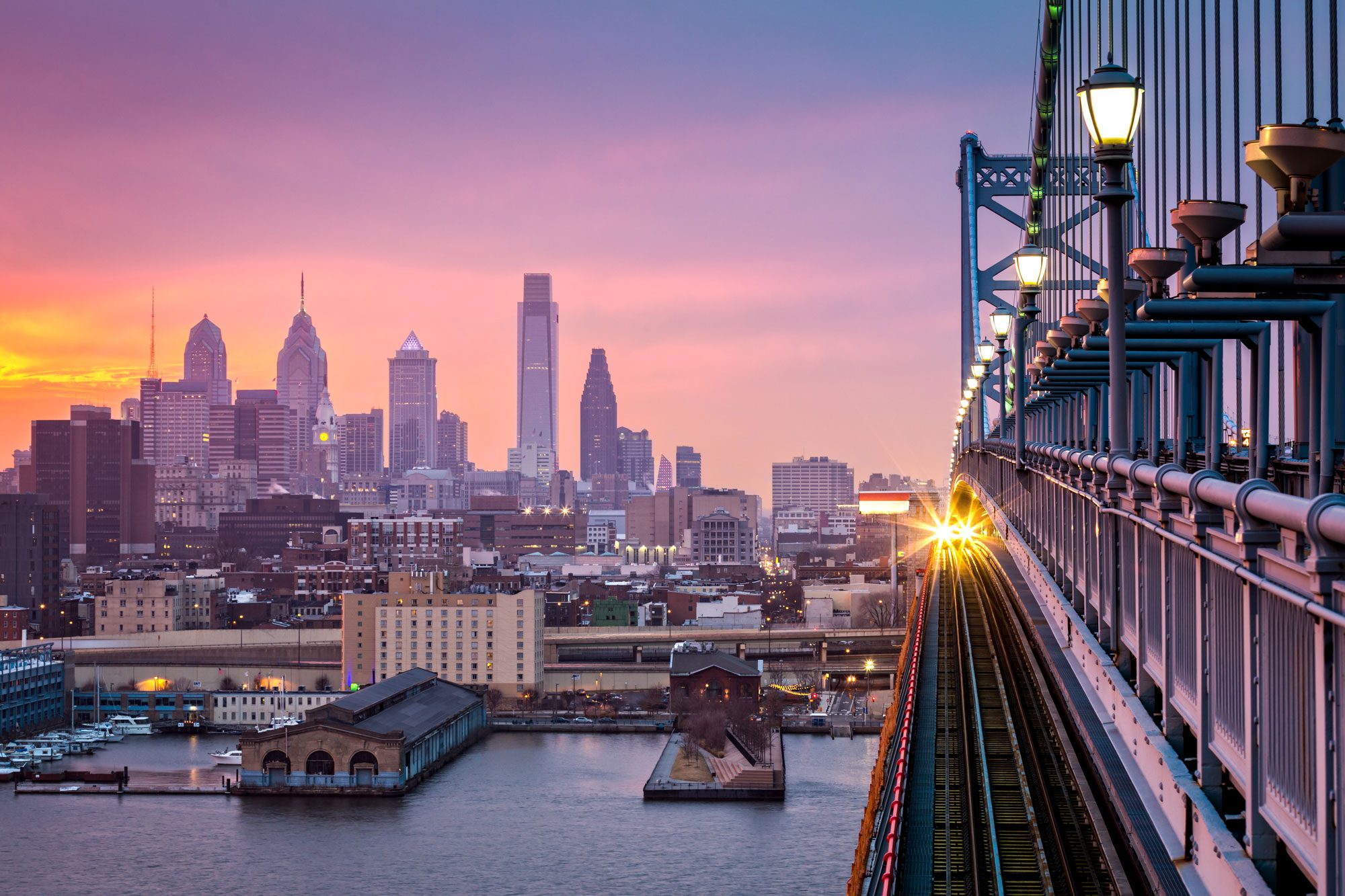 Philadelphia skyline with the sun rising.