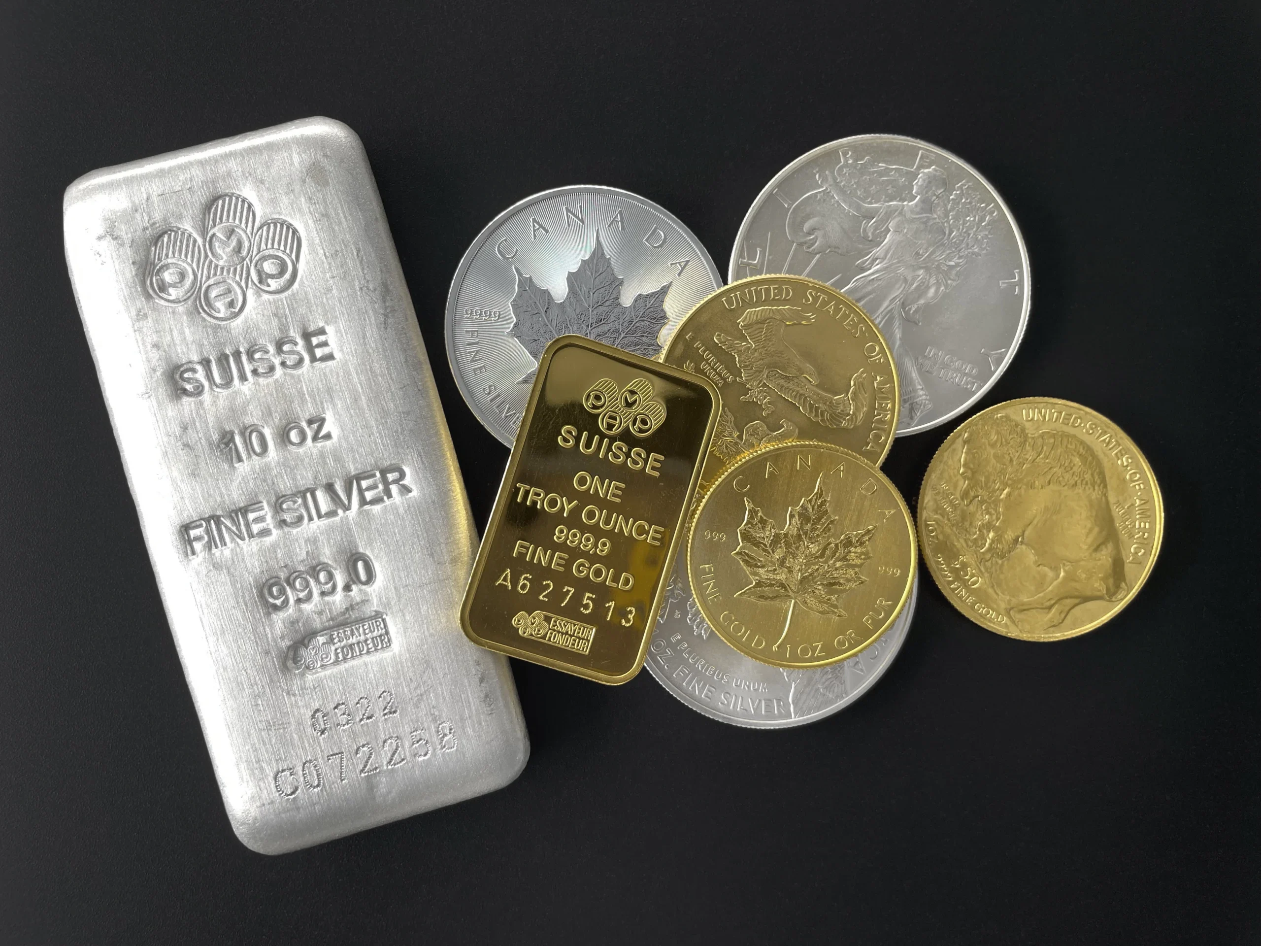 Assorted silver and gold bullion and coins in a pile