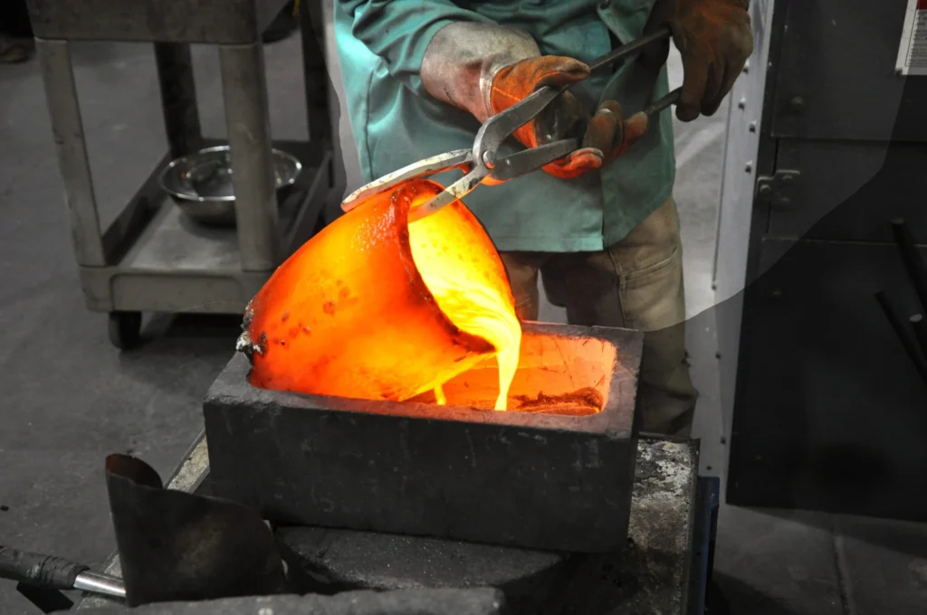 A gold refiner pouring liquid gold into a crucible