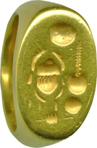 Egyptian signet gold ring on a white background