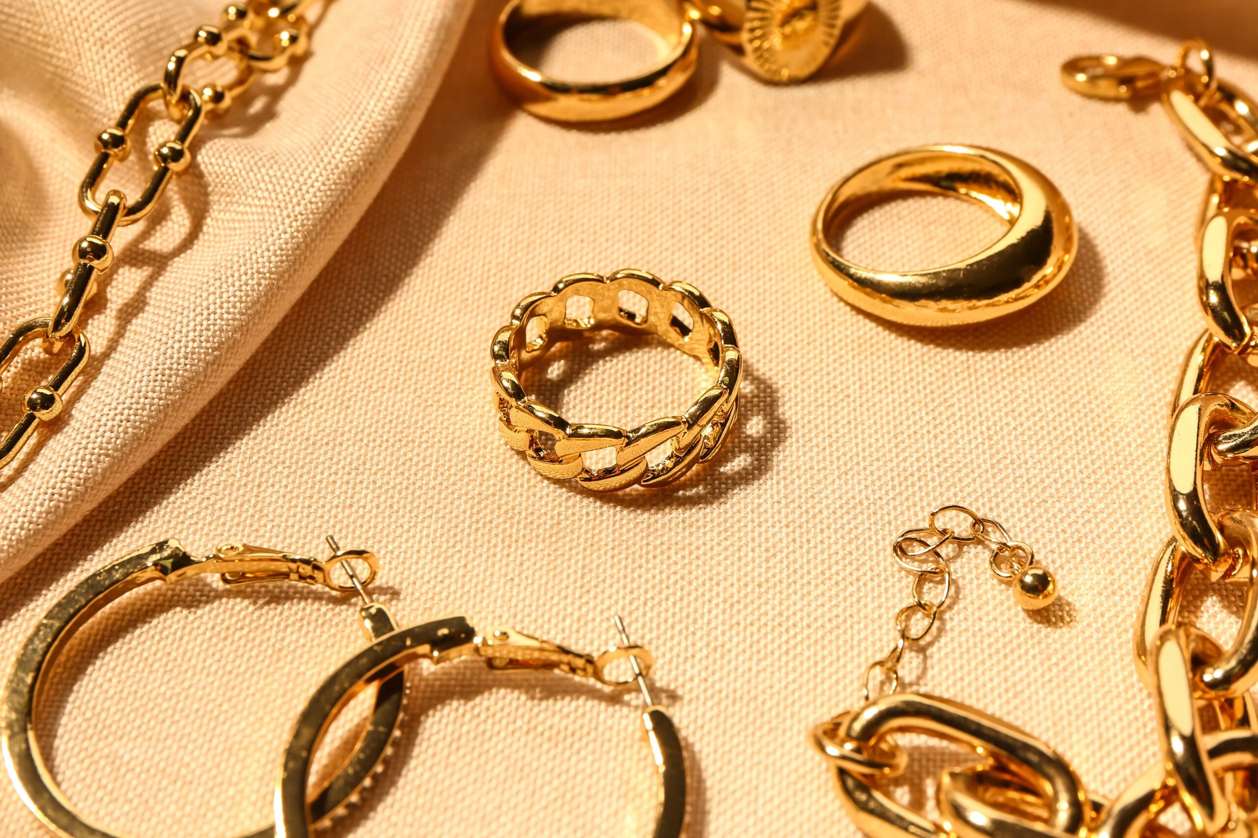 Beautiful gold vermeil jewelry on color fabric background